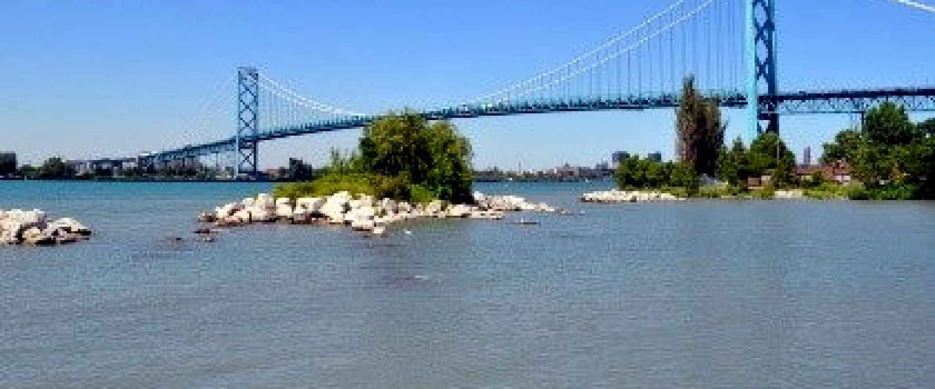 The Ambassador Bridge spanning over the Detroit River from the Canadian side, west of the bridge. 
