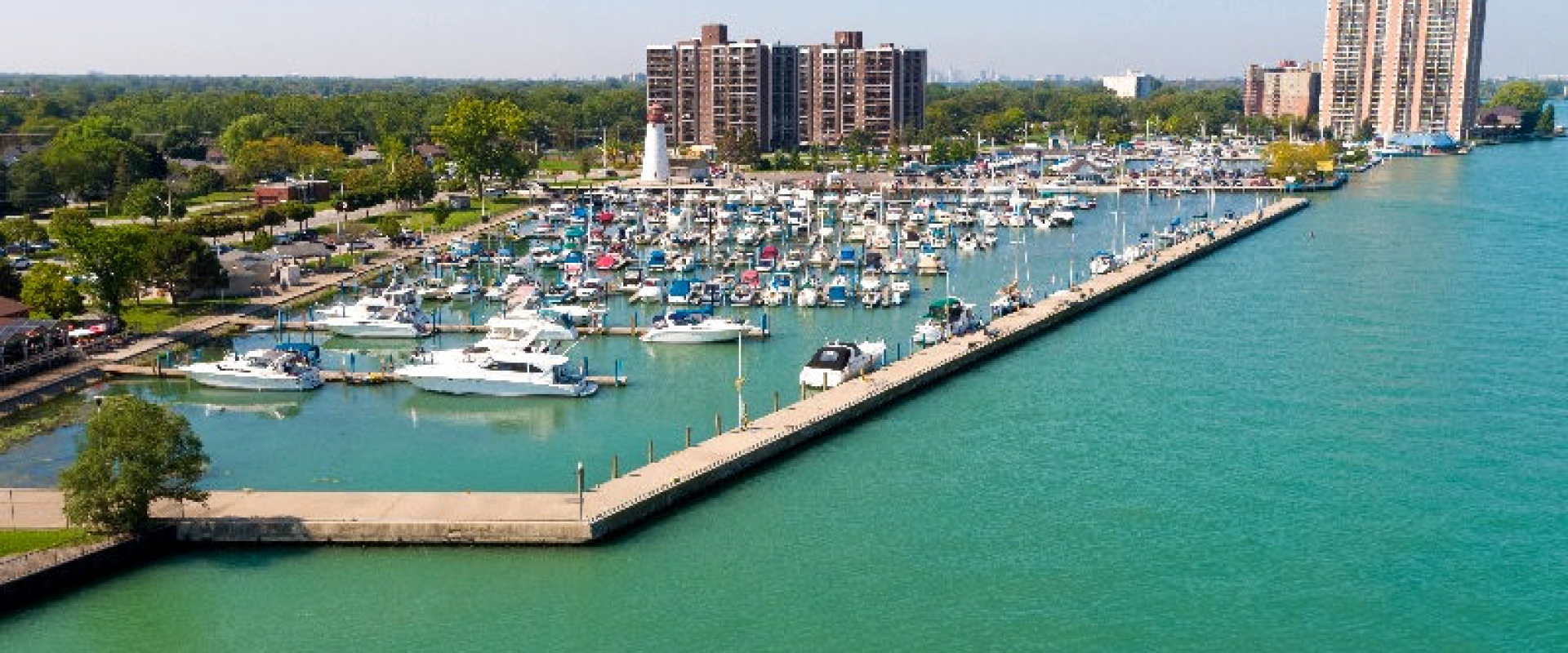 A marina with several boats harboured along the Detroit River. 