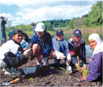 A group of New Canadians and Youth involved in activity of planting at Humber River, Onatrio
