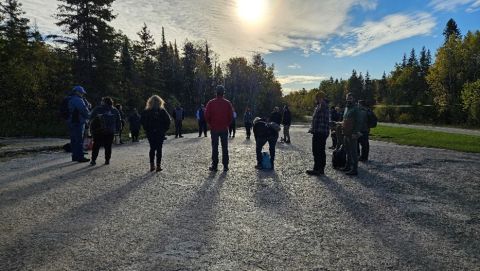 Participants standing in a circle at the Bannock Point Petroforms site (left) and a closeup up at a petroform (right) at Whiteshell Provincial Park.